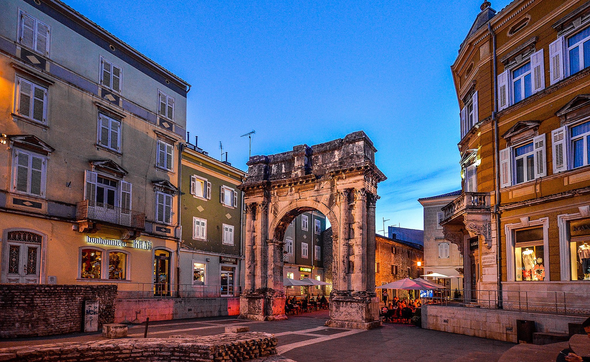Triumphal Arch of the Sergi of 'Golden Gate' is famous landmark in Pula, Croatia near Apartments Borina. It is located on Portarata Square. The Arch stands on the entrance of old town of Pula and it is situated in the city center. It is completely made out of stone. Stone tiles on the square and buildings around the gate.